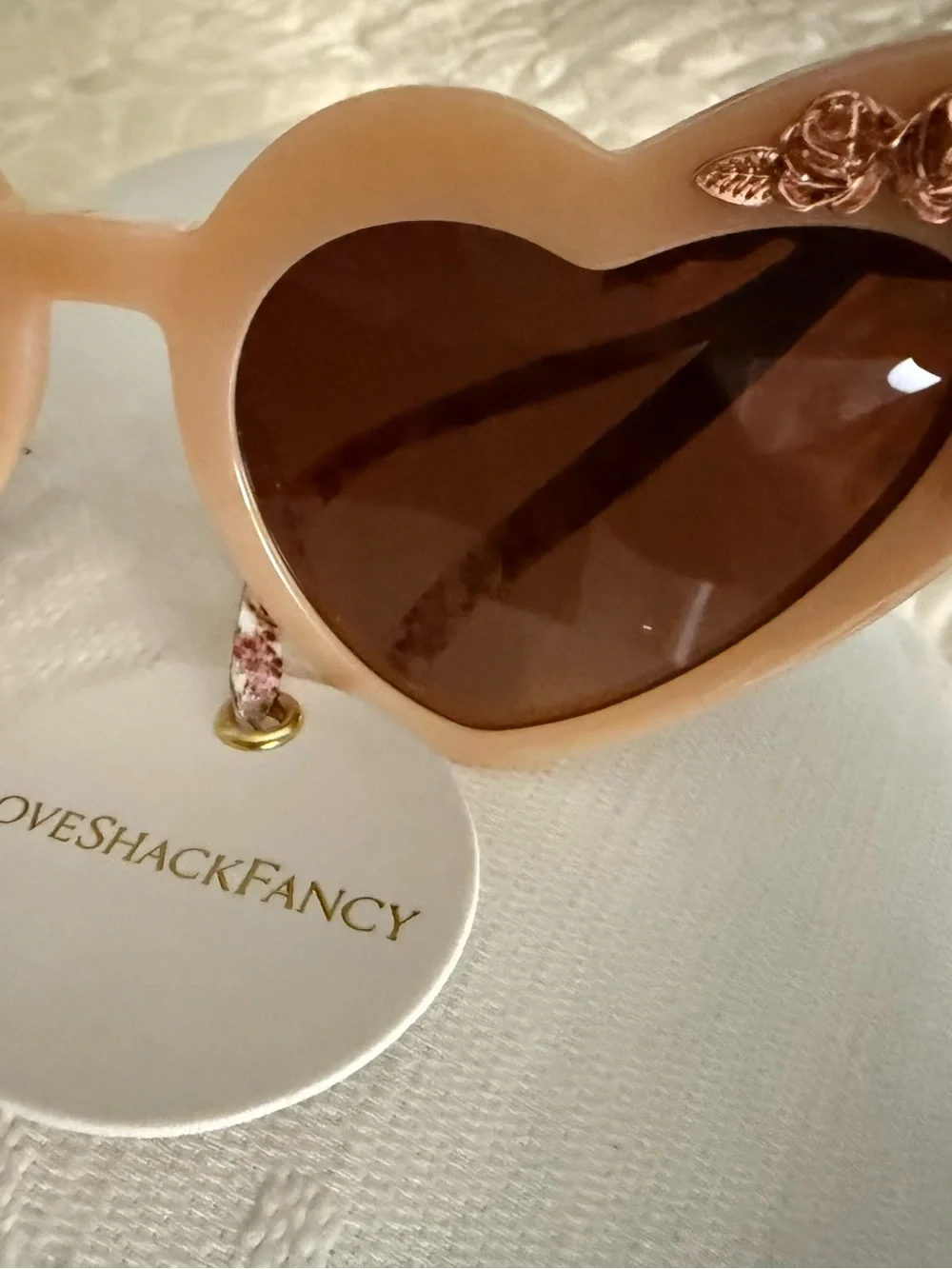 LoveShackFancy pink peach heart sunglasses with rose-gold floral embellishment